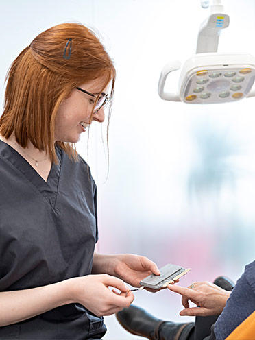 Dentist Showing Patient Fillings Options