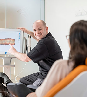Dentist Pointing Out Section Of 3D Scan