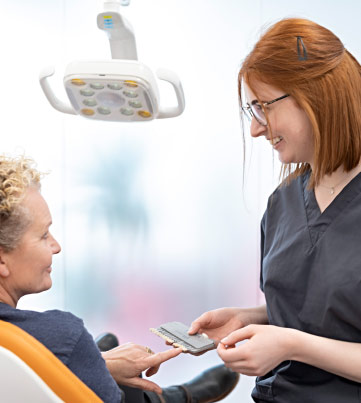 Dental Nurse Giving Advice To Patient