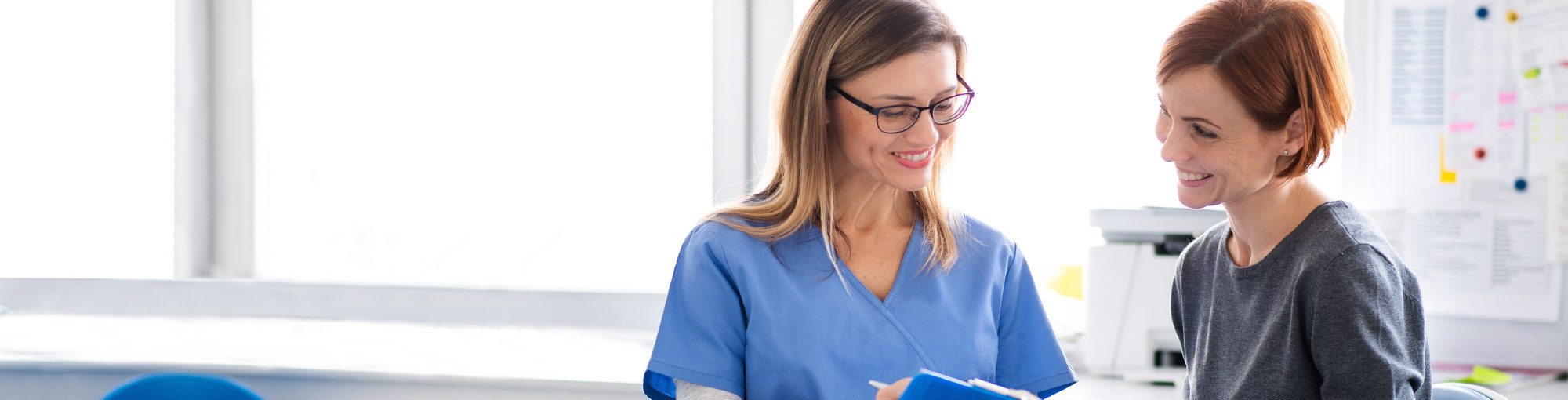 Two People Looking At Dental Chart