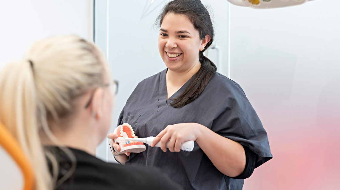 Dental Nurse Showing How To Brush Teeth